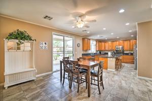 a kitchen with a table and chairs and a ceiling fan at about 3,900 Sq Ft North Vegas Escape with RV Parking! in Las Vegas