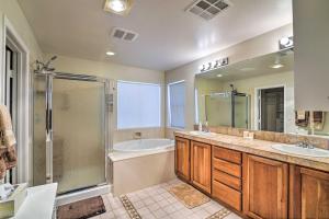 a bathroom with two sinks and a shower and a tub at about 3,900 Sq Ft North Vegas Escape with RV Parking! in Las Vegas