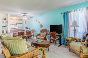 a living room filled with furniture and a tv at Hale Honu in Waikoloa Village