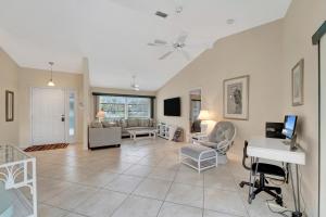 a living room with a couch and a desk at Tropical Oasis in Port Charlotte
