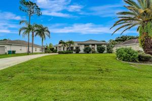 a large yard with houses and palm trees at Tropical Oasis in Port Charlotte