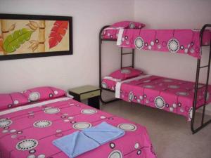 a bedroom with two bunk beds with pink sheets at Hotel Bellavista Isla del Sol in Prado