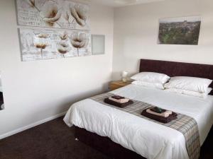 a bedroom with a bed with two bags on it at Vale View in Richmond