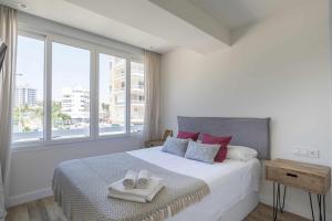 a bedroom with a bed with two towels on it at Eurosol sunny beach apartment in Torremolinos