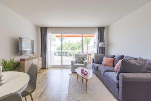 a living room with a couch and a table at Eurosol sunny beach apartment in Torremolinos