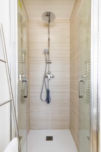 a bathroom with a shower with a glass door at Eurosol sunny beach apartment in Torremolinos