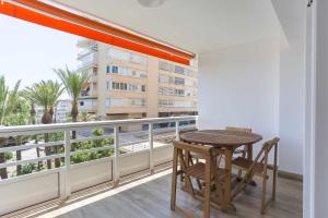 a table and chairs on a balcony with a view at Eurosol sunny beach apartment in Torremolinos