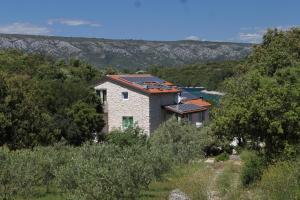 a house with solar panels on its roof at Seaside secluded apartments Cove Karkavac - Scedro, Hvar - 8801 in Jelsa