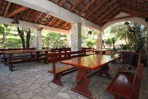 a pavilion with benches and a table in a room at Seaside secluded apartments Cove Karkavac - Scedro, Hvar - 8801 in Jelsa