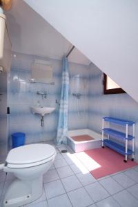 a bathroom with a toilet and a sink at Apartments by the sea Vrboska (Hvar) - 8748 in Vrboska