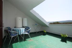 a room with chairs and a table in a attic at Apartments by the sea Vrboska (Hvar) - 8748 in Vrboska