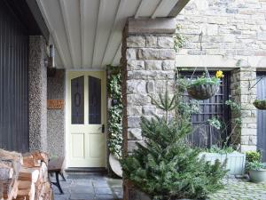 a front door of a house with a christmas tree at Valley View in Burnsall