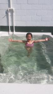 a young girl swimming in a swimming pool at Rotorua Thermal Holiday Park in Rotorua