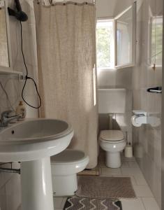a bathroom with a sink and a toilet and a window at Ostuni home nature in Ostuni