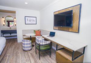 a hotel room with a desk and a tv at The Woodrose- NEWLY RENOVATED in Willits
