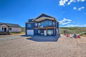 a house with a large window on a gravel driveway at Garden City Retreat with Access to Bear Lake! in Garden City