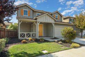a house with a orange door in a yard at Stunning River Islands Home Near Lake & Boat House in Lathrop