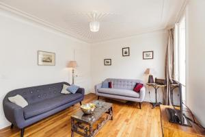 a living room with a couch and a table at Large Apartment For A Family 2 Adults Max! in Paris
