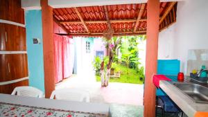 a kitchen with a sink and a table and chairs at Siyan Ka'an Bak'halal in Bacalar