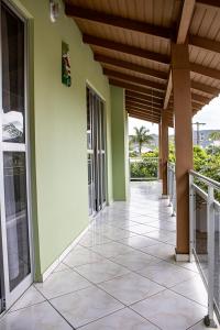 a porch of a house with a tiled floor at Residencial Elpidio in Bombinhas