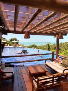 a patio with a view of a body of water at Villas do Pratagy Jambo I com Jacuzzy in Maceió