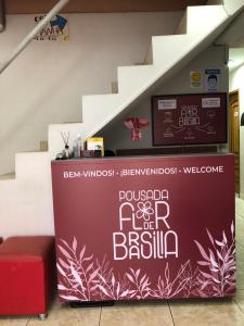 a wall with a sign on it next to some stairs at Pousada Flor De Brasília in Brasília
