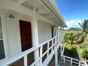 a front porch of a house with a red door at Ocean Breeze Villa Rentals in Oak Ridge
