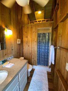 a bathroom with a sink and a toilet and a door at Ocean Breeze Villa Rentals in Oak Ridge