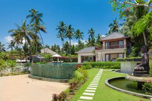 a villa with a swimming pool and a house at Villa Tirta Nila by Elite Havens in Candidasa