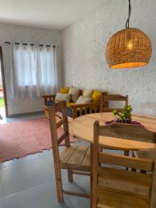 a room with a table and chairs and a couch at Casa de praia Prado Ba Doces magnólias in Prado