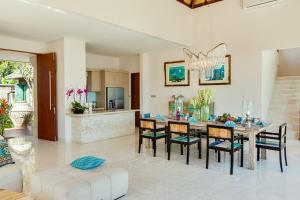 a kitchen and dining room with a table and chairs at Villa Tirta Nila by Elite Havens in Candidasa