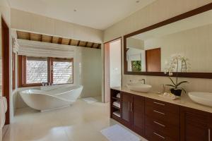 a bathroom with two sinks and a bath tub and a tub at Villa Tirta Nila by Elite Havens in Candidasa +28 photos