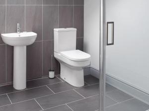 a bathroom with a toilet and a sink at The School House in New Luce