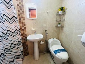 a bathroom with a sink and a toilet and a bidet at Mega Suite in Privileged area of San Marino in Guayaquil