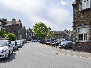 a city street with cars parked on the side of the road at Lower Sycamore Cottage in Ambleside