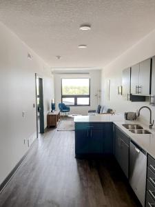 a kitchen with a sink and a counter top at Sleepover 1BD 1BA Des Moines Apartments in Des Moines