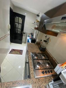 a kitchen with a stove and a counter top at Appartement de lux in Casablanca