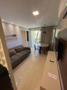a living room with a couch and a table at Beach Class Muro Alto 6308 in Porto De Galinhas