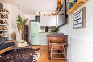 a kitchen with a refrigerator and a table in a room at The Cozy Villa-private parking in Miami