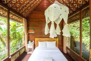 una camera da letto in una casa sull'albero con un letto di Bali Jungle Resort a Tegalalang