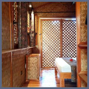 a room with a door with a table and a window at At Home in Puerto Princesa City