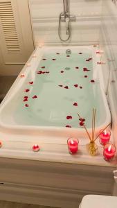 a bath tub with red candles in it at Holiday House near Butuan City Airport in Butuan