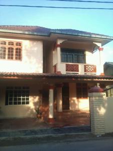 a large white house with a porch at Z&R HOMESTAY in Kota Bharu
