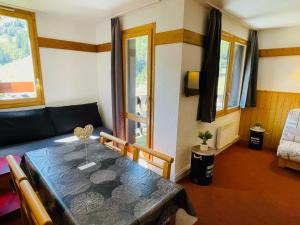 a living room with a table and a couch at Appartement La Plagne-Tarentaise, 2 pièces, 5 personnes - FR-1-351-163 in La Plagne Tarentaise