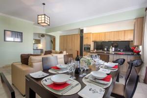a living room with a dining table and a kitchen at By the Beach Duplex Apartment, Armacao de Pera, Algarve - Portugal in Armação de Pêra
