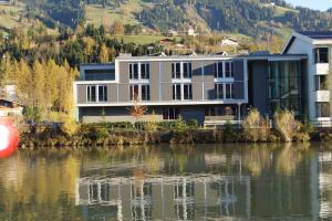 a house on the side of a body of water at Hostel-Jugendherberge St. Johann im Pongau in Sankt Johann im Pongau