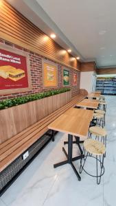 a row of tables and chairs in a restaurant at SOVRANO HOTEL BATAM fka PARKSIDE SOVRANO HOTEL in Nagoya