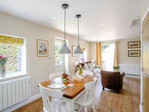 a kitchen and living room with a table and chairs at Wits End Cottage in Martin