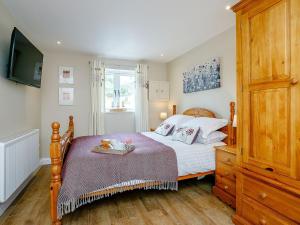a bedroom with a bed with a tray on it at Wits End Cottage in Martin