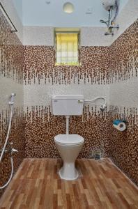 a bathroom with a toilet and a shower in it at deb Guest House And Banquet hall in Kolkata